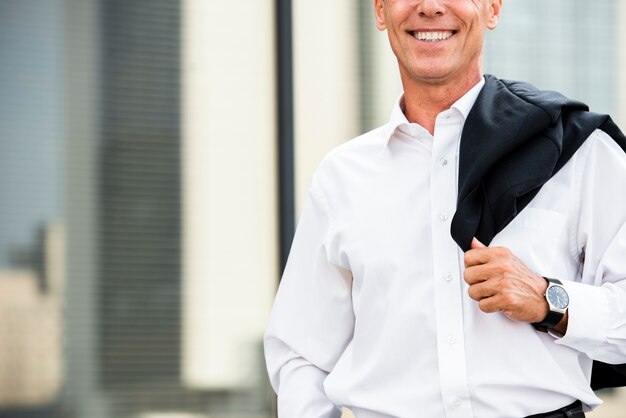 Close-up smiling businessman near glass building