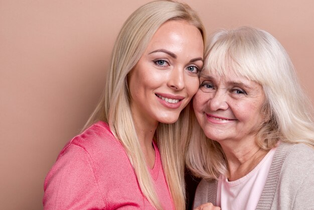 Close-up smiling daughter and mother