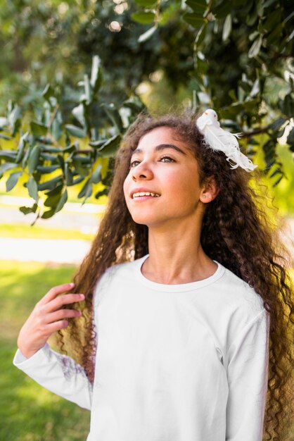 Close-up of a smiling girl standing in park