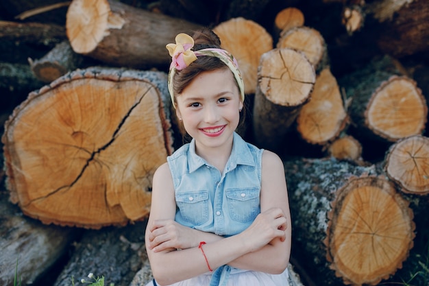 Free photo close-up of smiling kid with firewood background