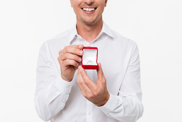 Free photo close up of a smiling man showing open box