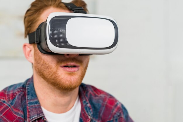 Close-up of a smiling man wearing virtual reality glasses