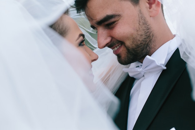 Close-up of smiling newlyweds' faces