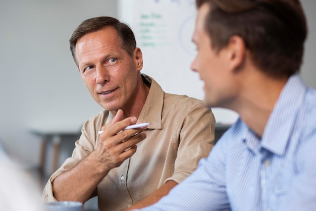 Free photo close up on smiling person in conference room