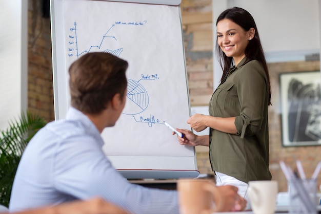 Close up on smiling person in conference room