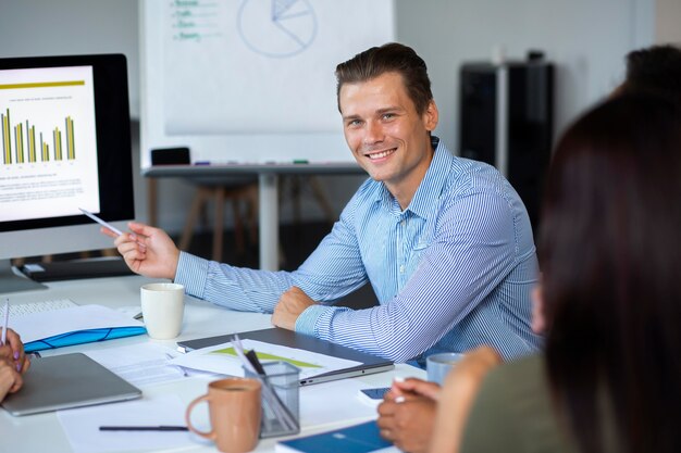 Close up on smiling person in conference room