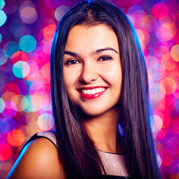 Close-up of smiling woman in nightclub