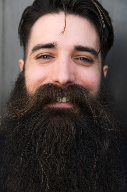 Close-up of  a smiling young bearded man