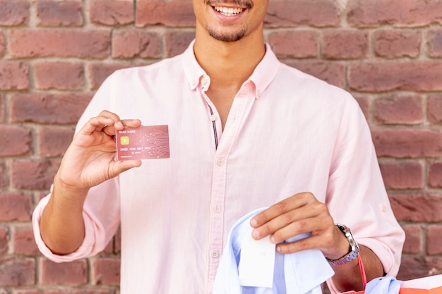 Close-up smiling young man holding card