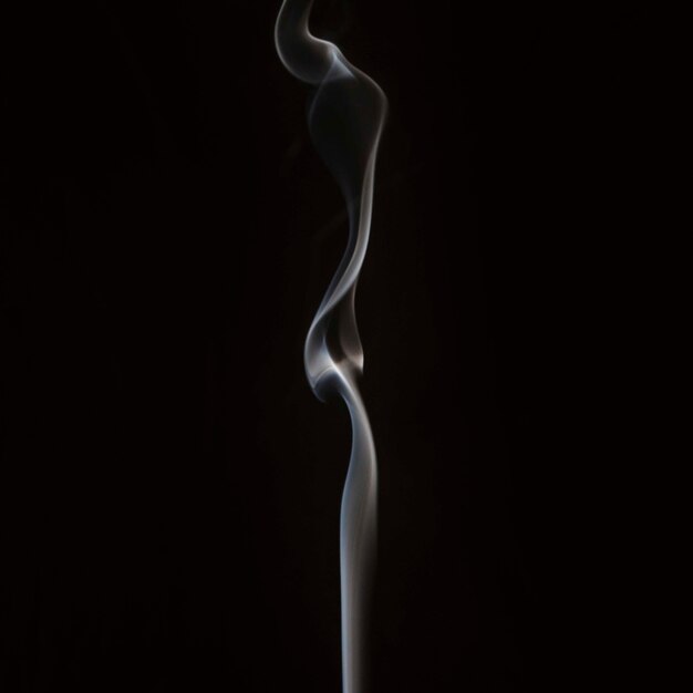 Close-up of smoke swirling against black backdrop