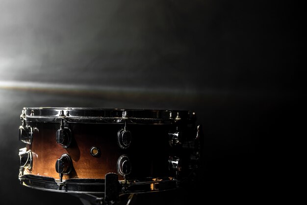 Close-up, snare drum on dark background with stage spotlight, copy space.