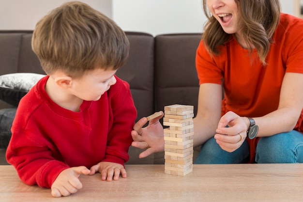 Close-up son and mom playing janga