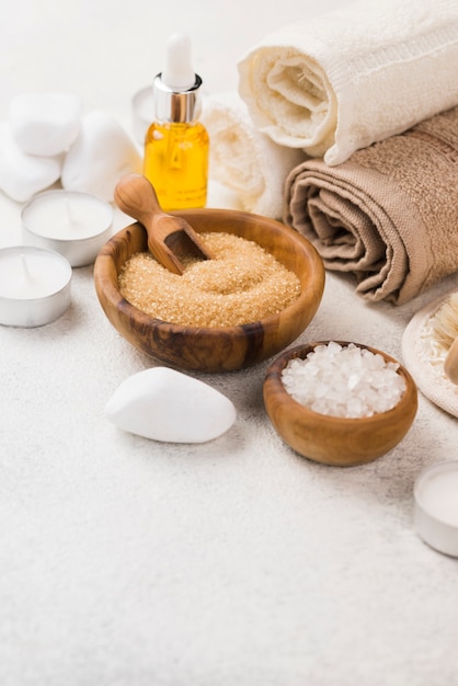 Close-up spa accessories with towels and oil