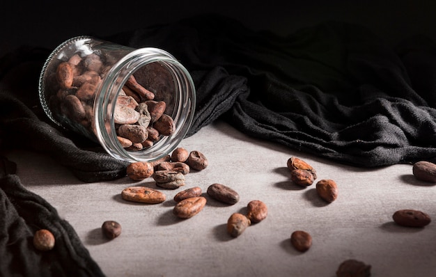 Close-up spilled jar with cocoa beans