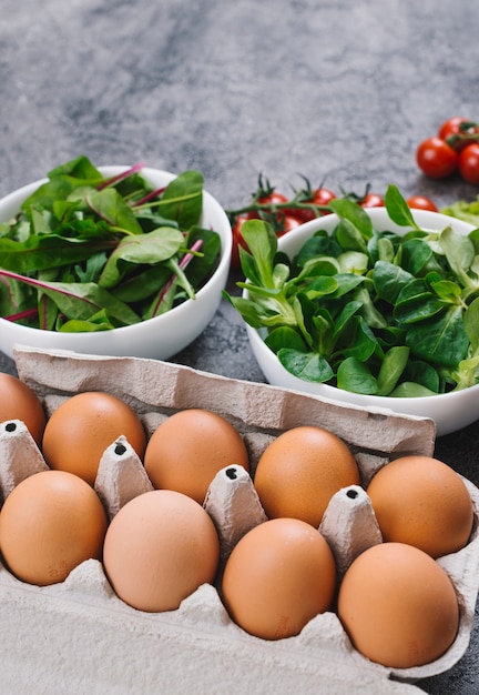 Close-up of spinach and eggs in the carton