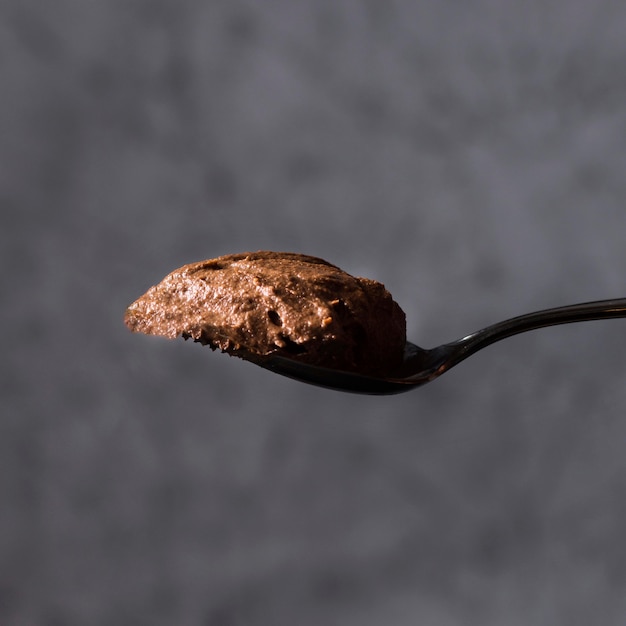 Close-up spoon with tasty chocolate mousse