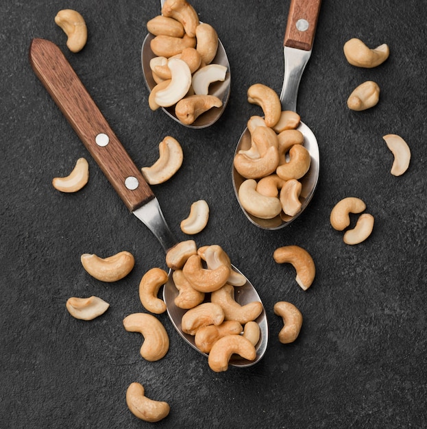 Close-up spoons filled with healthy raw cashew nuts