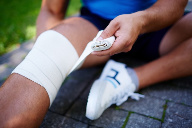 Close-up of sportsman with knee sprain