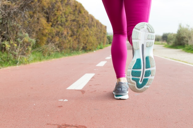 Free photo close-up of sportswoman training alone on stadium