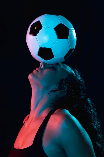 Close-up sporty woman with soccer ball