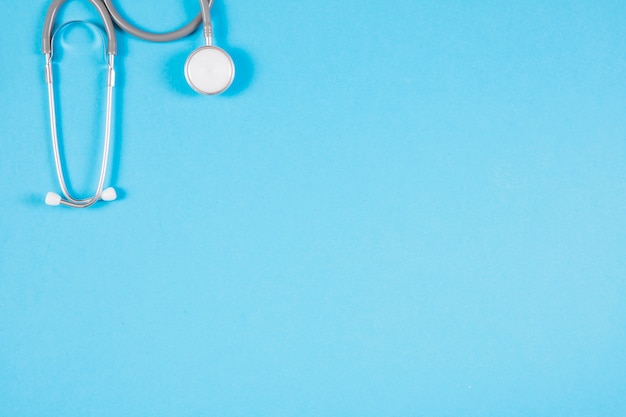 Close-up of stethoscope on blank blue background