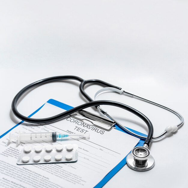 Close-up stethoscope with tablets and medical form