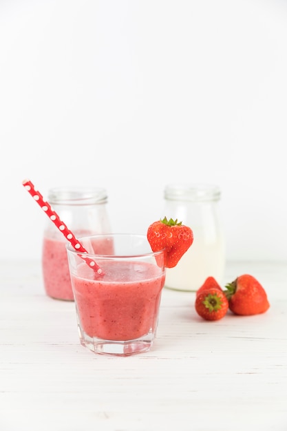 Close up strawberry smoothie glasses on table