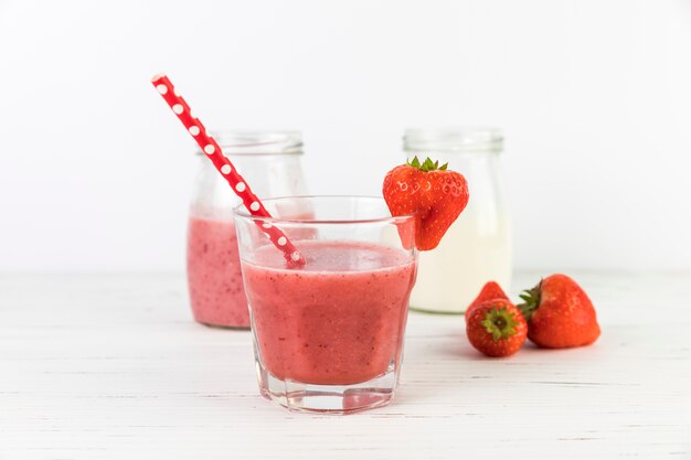 Close up strawberry smoothie glasses on table