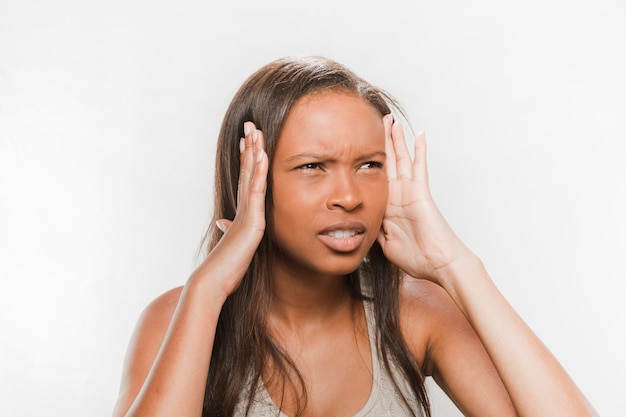 Close-up of a stressed teenage girl on white background