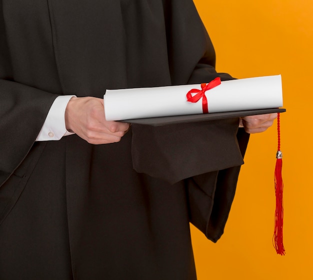 Close up student holding diploma