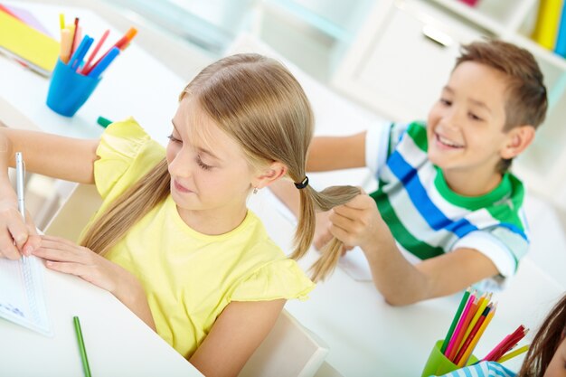 Close-up of student playing with his classmate