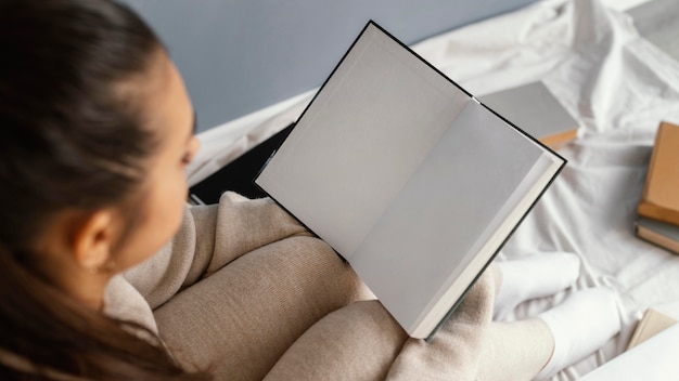 Close up student reading in bed