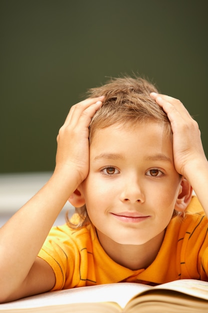 Close-up of student reading a book in class