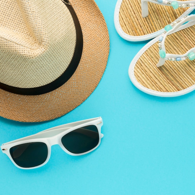 Close-up summer hat and slippers with glasses