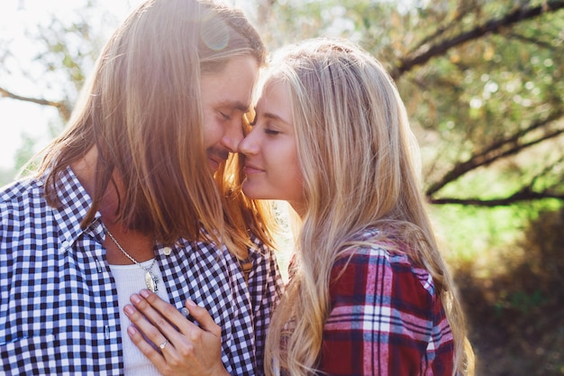 Free photo close up summer warm romantic portrait of two people, couple in love kissing and hugging.