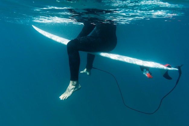 Close up surfer sitting on surfboard