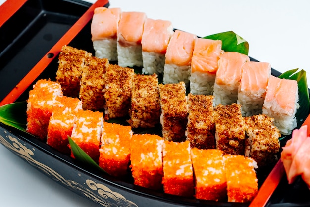 Free photo close up of sushi set with hot and cold rolls