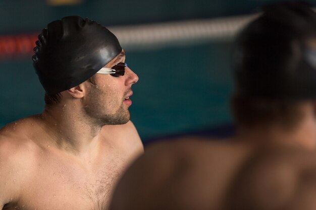 Close up of a swimmer in cap and swimming goggles