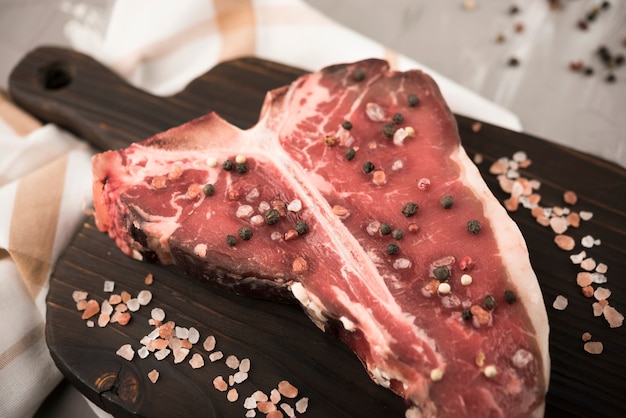 Close-up t-bone steak and ingredients in kitchen