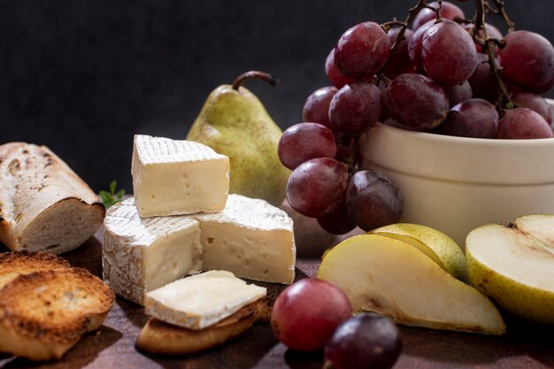 Close-up tasty brie cheese and grapes