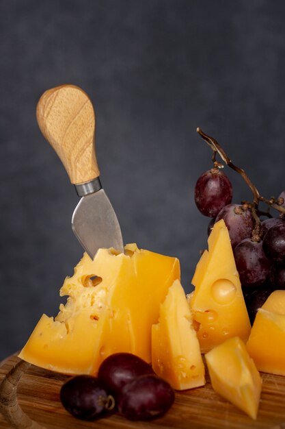 Close-up tasty cheese with grapes