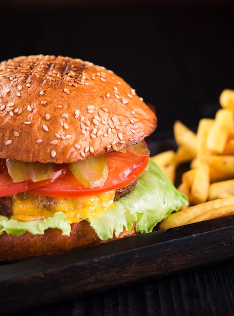 Close-up tasty cheeseburger with french fries