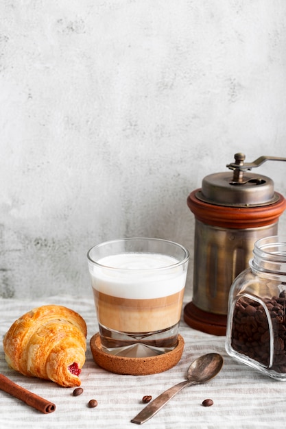 Close-up tasty coffee with milk and croissant