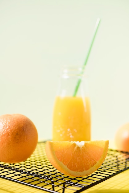 Free photo close-up tasty orange juice with straw