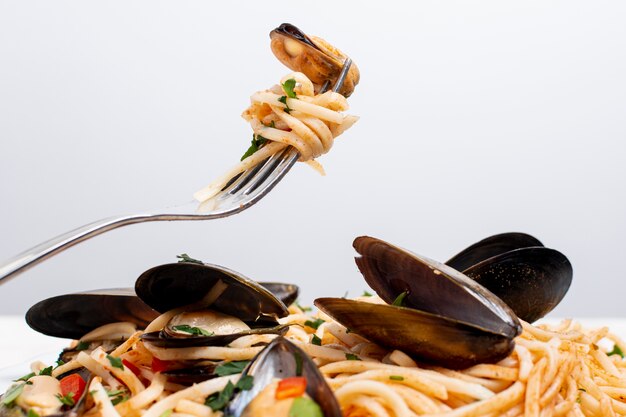 Close-up tasty pasta with mussels