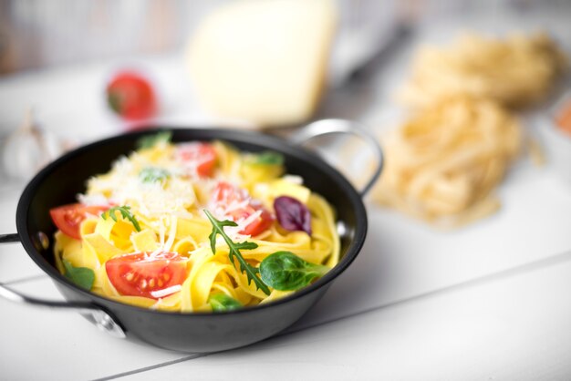 Close-up of tasty tagliatelle with fresh ingredient and cheese