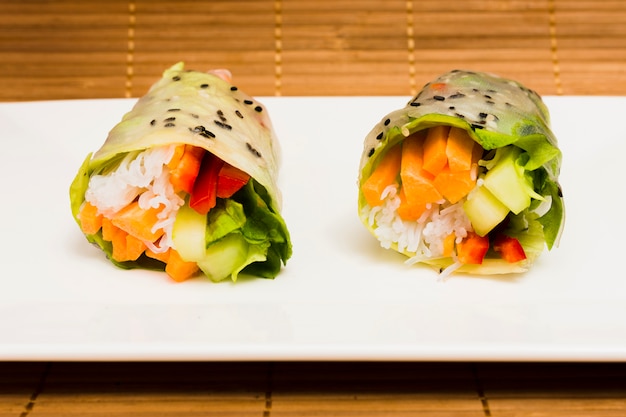 Close-up of tasty vegetable rice spring and sesame seeds on plate