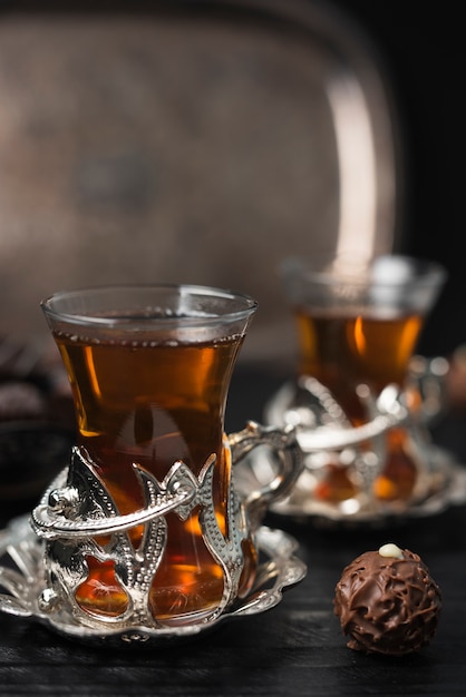 Close-up of tea glasses and truffle