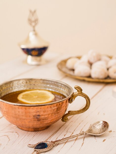 Close up tea next to pastries