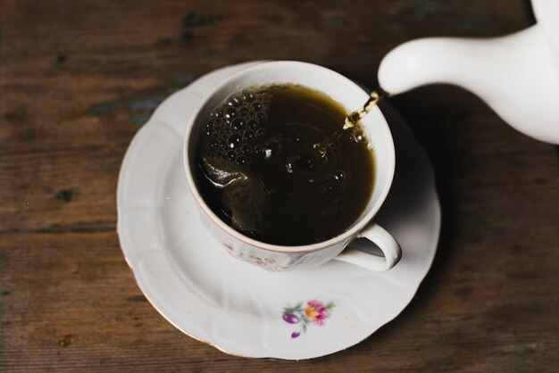 Close-up tea pouring into cup